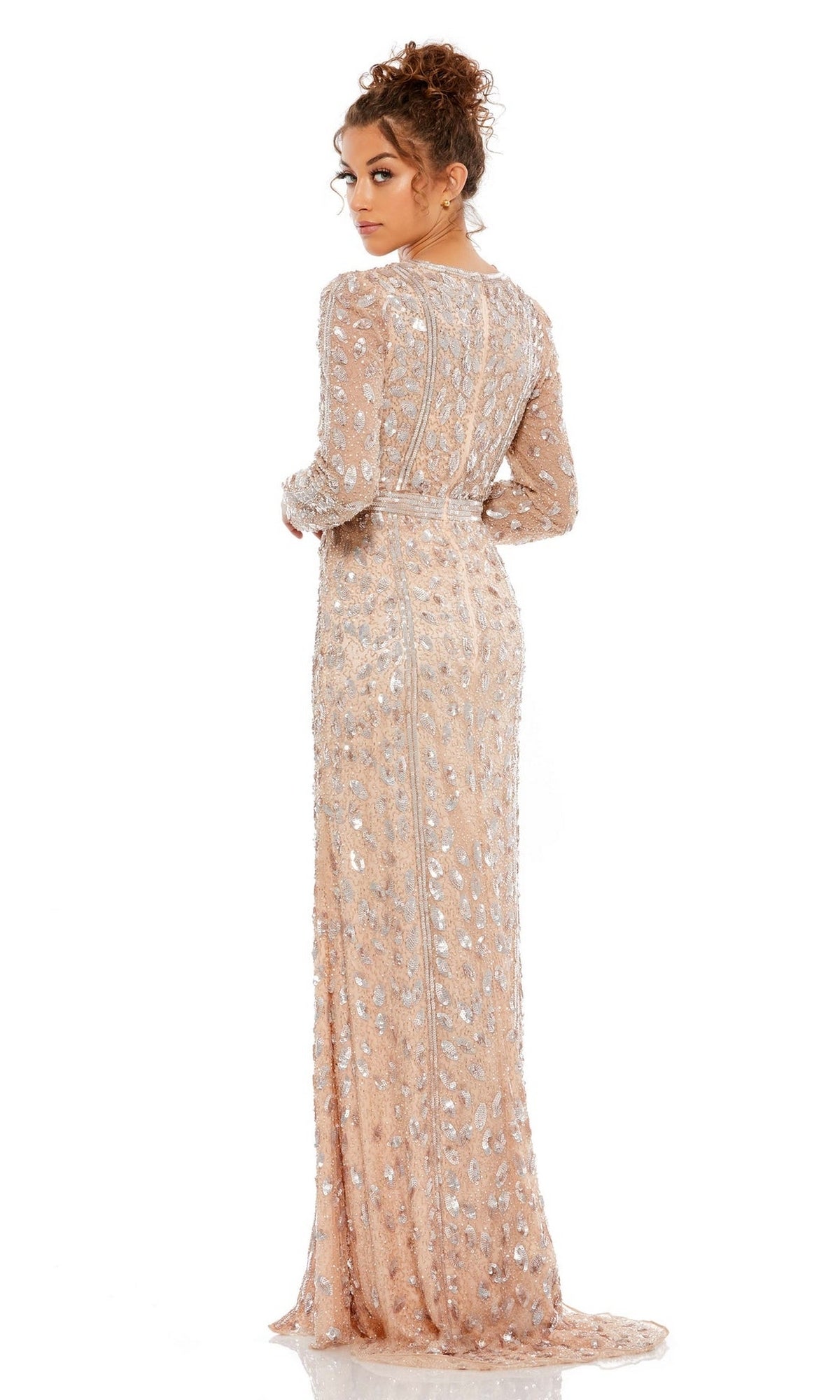 A woman with curly hair in an updo models the Long Formal Dress 5002 by Mac Duggal, a long-sleeve, floor-length formal gown adorned with silver sequins, shown from the back against a white background.